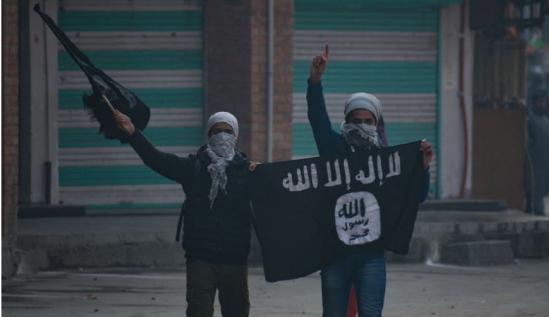 Kashmiri masked protester waving flags during clashes in Nowhattah Srinagar after Friday prayers on 21st December 2018