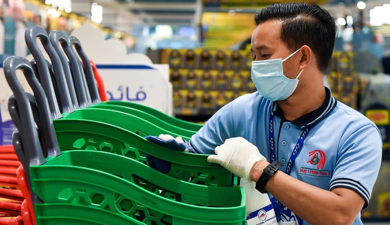In Dubai an employee sterilises shopping Carts at The Hypermarket Prevent Coronavirus Disease