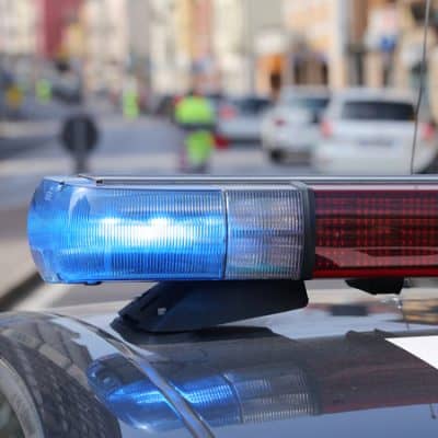 Blue flashing sirens of police car during the roadblock in the city