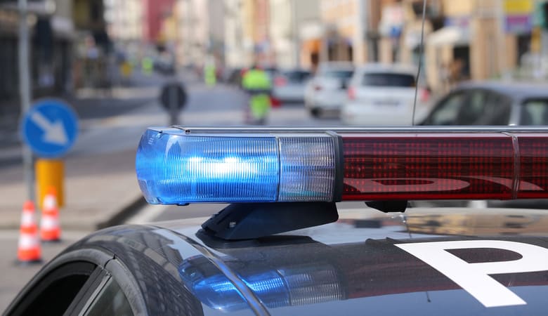 Blue flashing sirens of police car during the roadblock in the city