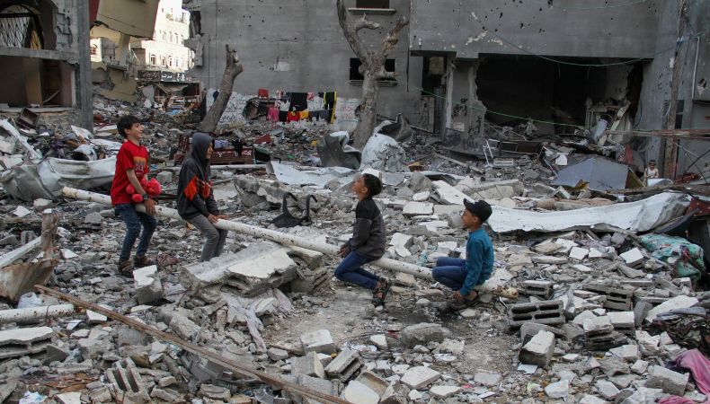 children play in rubble of gaza for eid holiday